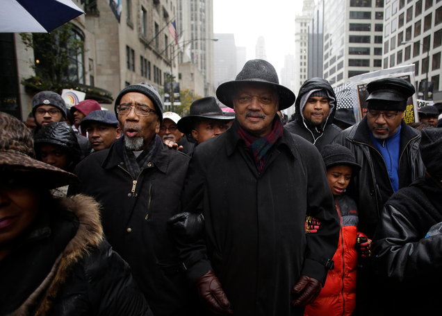 U.S. Representative Bobby Rush and Reverend Jesse Jackson link arms as they march with demonstrators protesting the shooting of Laquan McDonald along the Magnificent Mile November 27, 2015 in Chicago, Illinois.